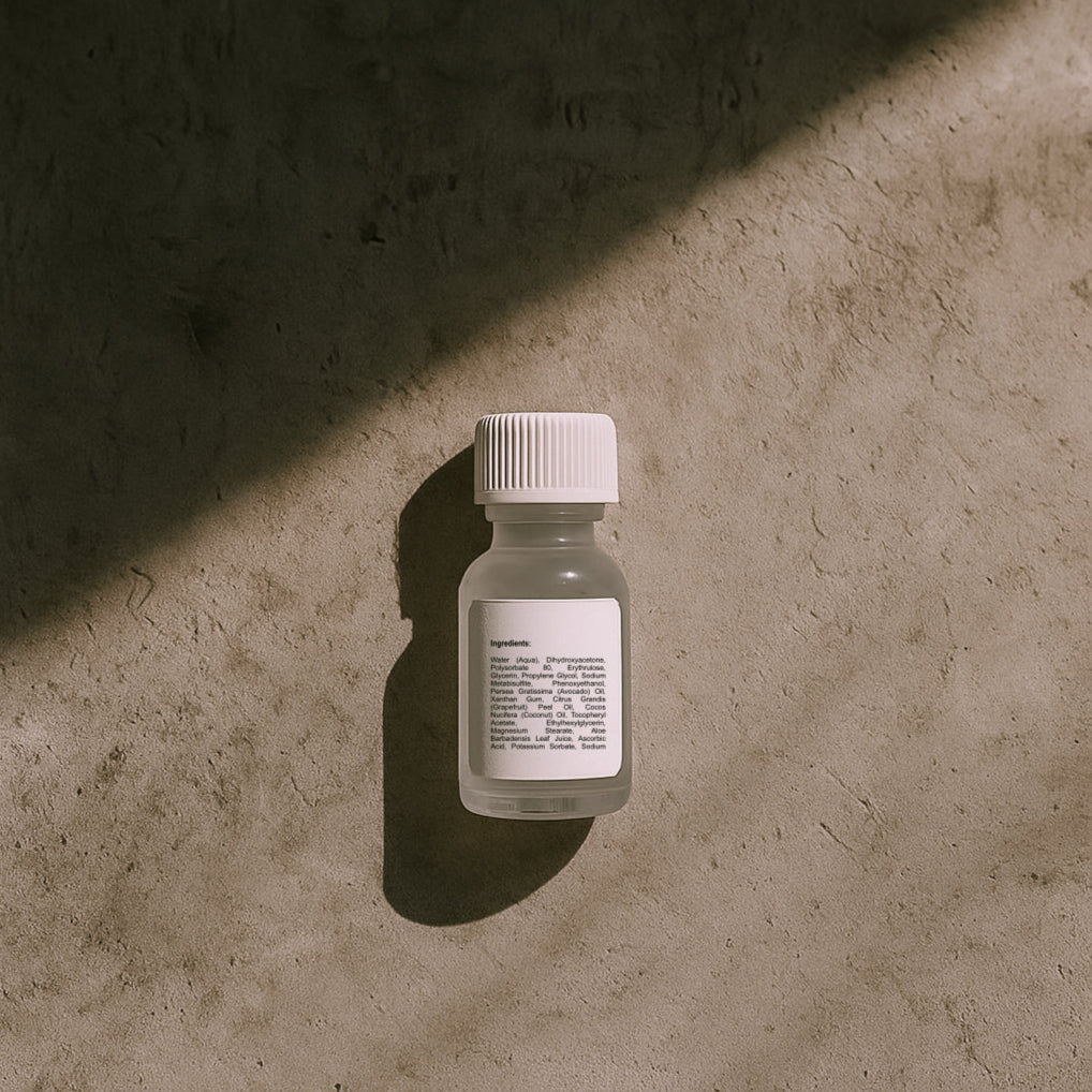 Small bottle with a label on a textured surface, showing the list of ingredients featured in the product