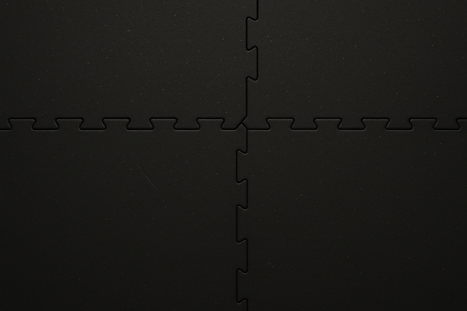 Black interlocking foam mat tiles on a black background